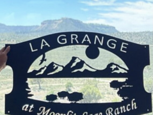 Metal sign mountains and sage brush sign