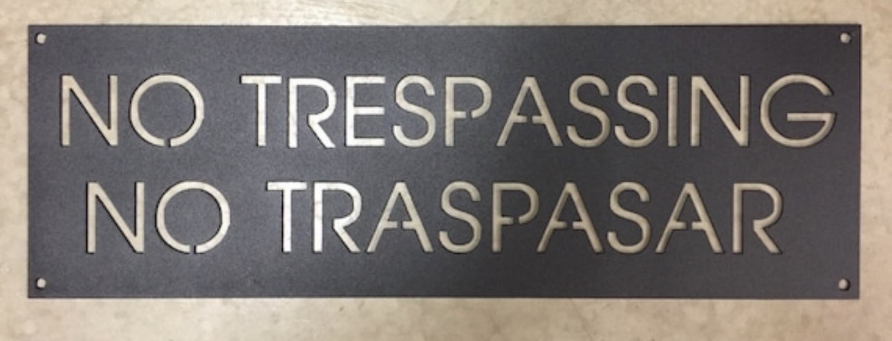 Metal NO TRESPASSING NO TRESPAR sign, spanish no trespassing